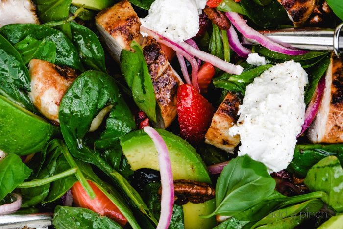 Grilled Chicken Salad with Strawberries and Avocado Recipe - This simple grilled chicken salad is made with fresh spinach, sweet berries and creamy avocado, then tossed with a quick balsamic dressing. Ready in 30 minutes! // addapinch.com