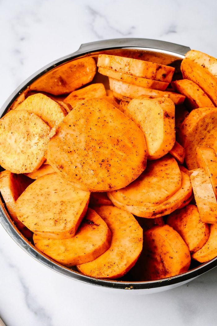 Sweet potato slices coated in spices and olive oil // addapinch.com