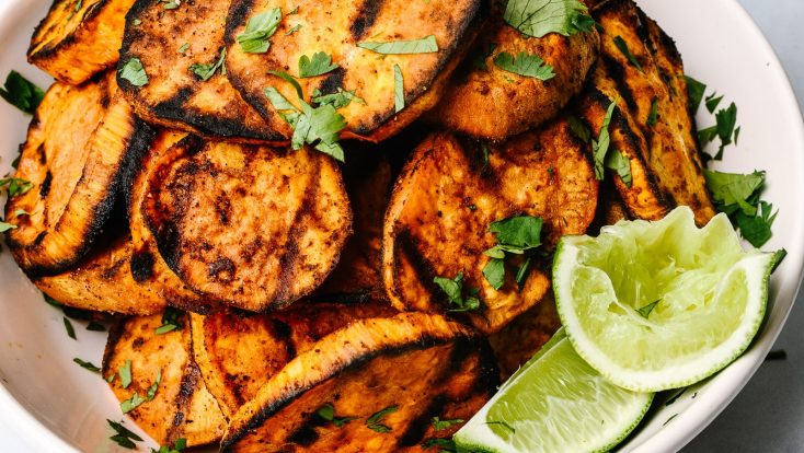 These Spicy Grilled Sweet Potatoes make the perfect side dish! Tender grilled sweet potatoes are coated with a delicious blend of spices for a subtle spicy kick! Ready in minutes! // addapinch.com