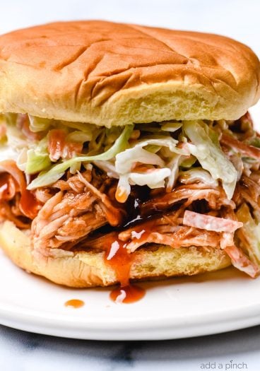 BBQ Chicken Sandwiches make an easy and delicious meal! Made with shredded chicken tossed in a flavorful BBQ sauce! Always a favorite! // addapinch.com