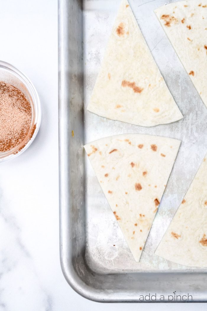 Cinnamon Sugar Tortilla Chips make a quick and easy recipe perfect for serving with your favorite sweet dips, salsa, or ice cream! Made with 4 ingredients and ready in minutes! // addapinch.com