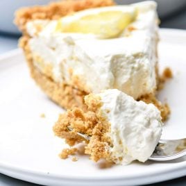 This no bake lemon cream pie is a quick and easy twist on the classic. Made with cream cheese, cream, and lots of lemon with a buttery graham cracker crust. // addapinch.com