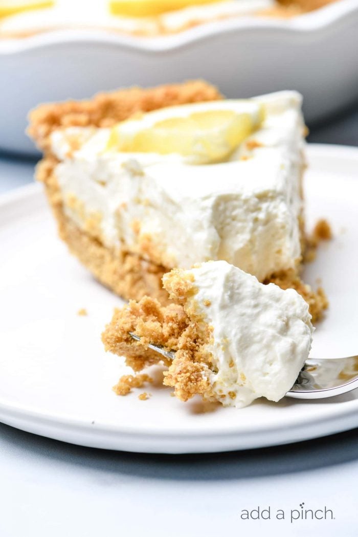 This no bake lemon cream pie is a quick and easy twist on the classic. Made with cream cheese, cream, and lots of lemon with a buttery graham cracker crust. // addapinch.com