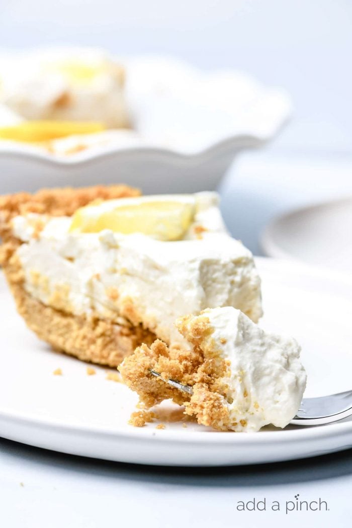 This no bake lemon cream pie is a quick and easy twist on the classic. Made with cream cheese, cream, and lots of lemon with a buttery graham cracker crust. // addapinch.com