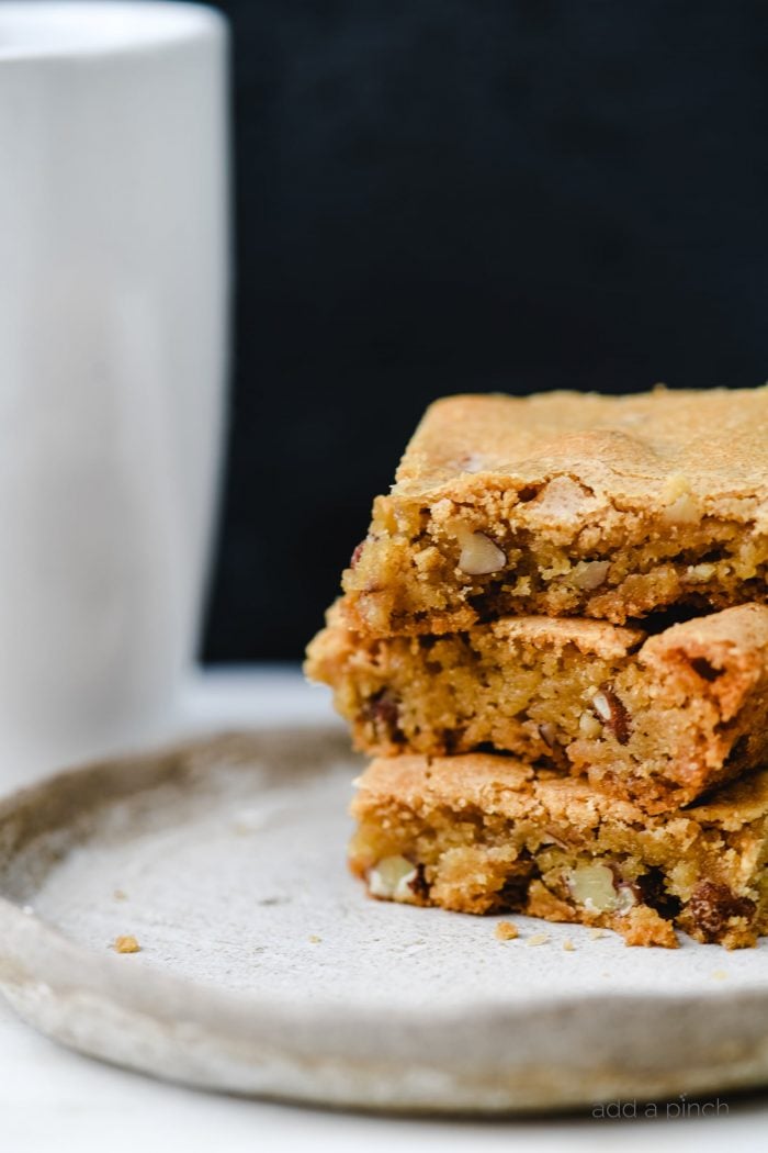 Stack of three Pecan Chewies on a natural pottery plate // addapinch.com