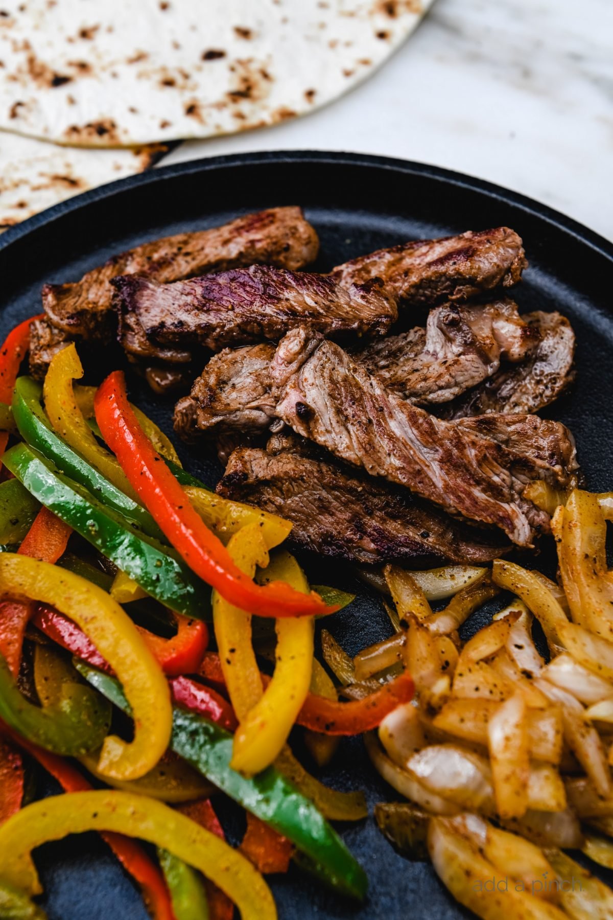 Rib Eye Fajitas Recipe - Ribeye Steak Fajitas are so quick, easy and flavorful! Made with perfectly seasoned, tender Ribeye steak, bell peppers and onions, they are always a favorite.