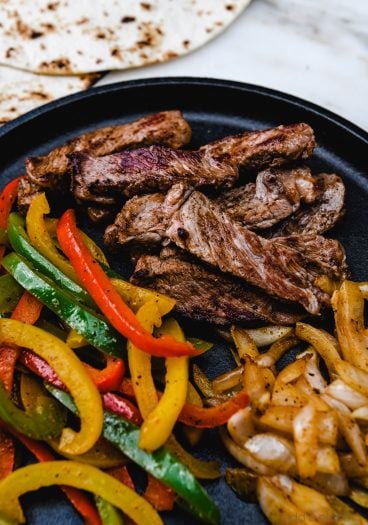 Rib Eye Fajitas Recipe - Ribeye Steak Fajitas are so quick, easy and flavorful! Made with perfectly seasoned, tender Ribeye steak, bell peppers and onions, they are always a favorite! // addapinch.com
