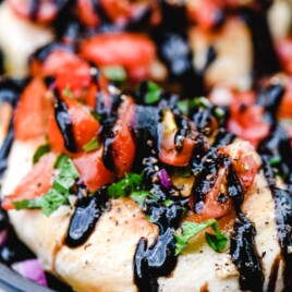 Easy Bruschetta Chicken Recipe with a rich balsamic glaze is delicious! Ready in less than 30 minutes, this easy chicken recipe is an all-time favorite! // addapinch.com