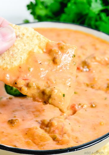 This Chili Cheese Dip makes the best quick and easy cheese dip! Made from scratch with shredded cheese, salsa, and cooked sausage, it is always a favorite! // addapinch.com