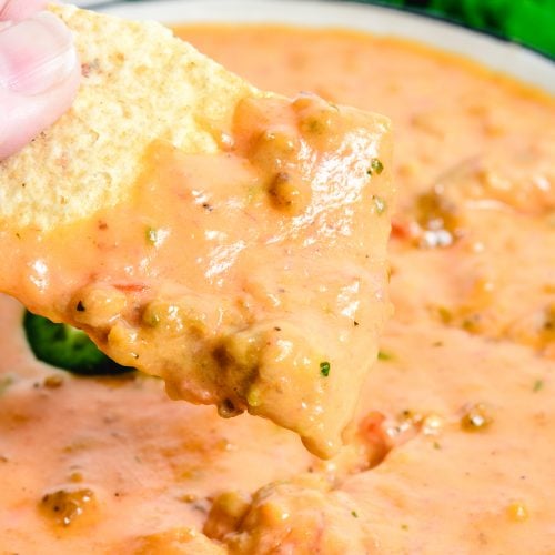 This Chili Cheese Dip makes the best quick and easy cheese dip! Made from scratch with shredded cheese, salsa, and cooked sausage, it is always a favorite! // addapinch.com