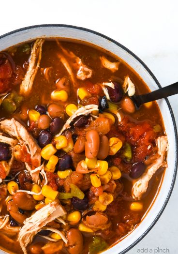 Chicken Taco Soup Recipe - So quick and easy, this chicken taco soup recipe is flavorful and delicious! Made with chicken, beans, corn, it is on the table in less than 30 minutes! // addapinch.com