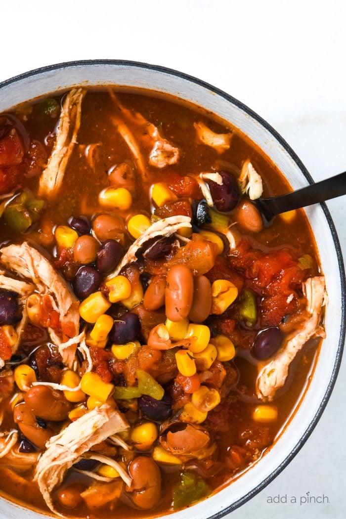 Chicken Taco Soup Recipe - So quick and easy, this chicken taco soup recipe is flavorful and delicious! Made with chicken, beans, corn, it is on the table in less than 30 minutes! // addapinch.com