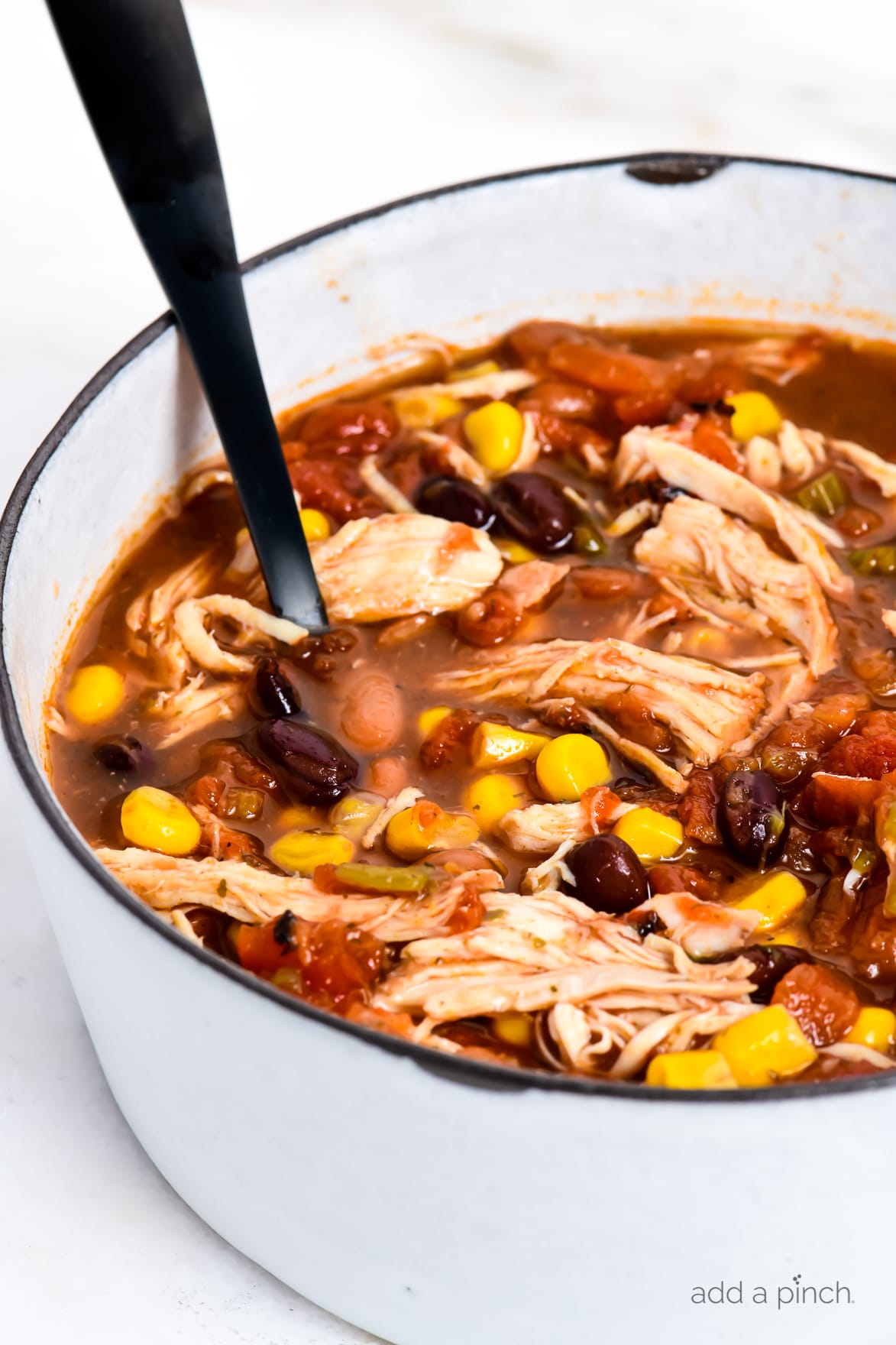 Chicken Taco Soup Recipe - So quick and easy, this chicken taco soup recipe is flavorful and delicious! Made with chicken, beans, corn, it is on the table in less than 30 minutes! // addapinch.com