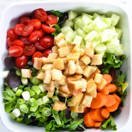 This simple salad recipe makes the best house salad that goes with anything! Made with simple greens and add-ins, this is the side salad of all side salad recipes! // addapinch.com