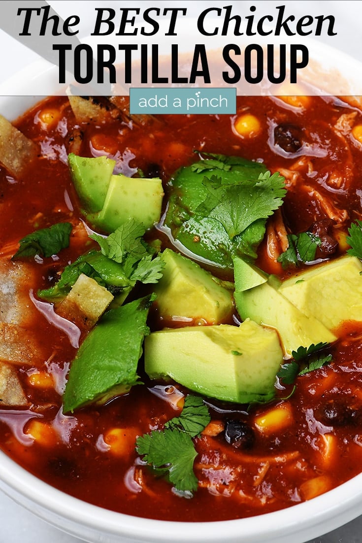 Bowl of Chicken Tortilla Soup topped with cilantro and avocado - with text - addapinch.com