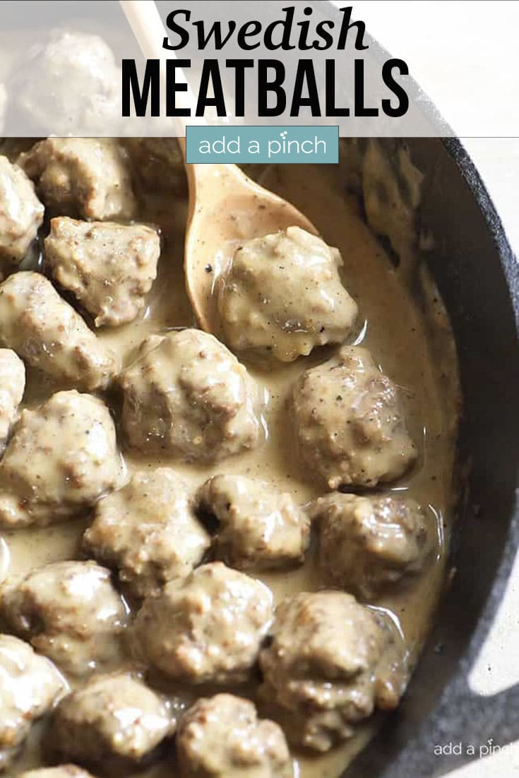 Swedish Meatballs with creamy sauce in iron skillet with wooden spoon - with text - addapinch.com