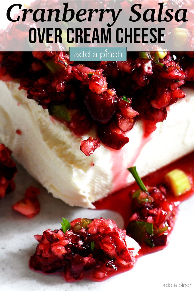 Cranberry Salsa over Cream Cheese on white plate - with text - addapinch.com