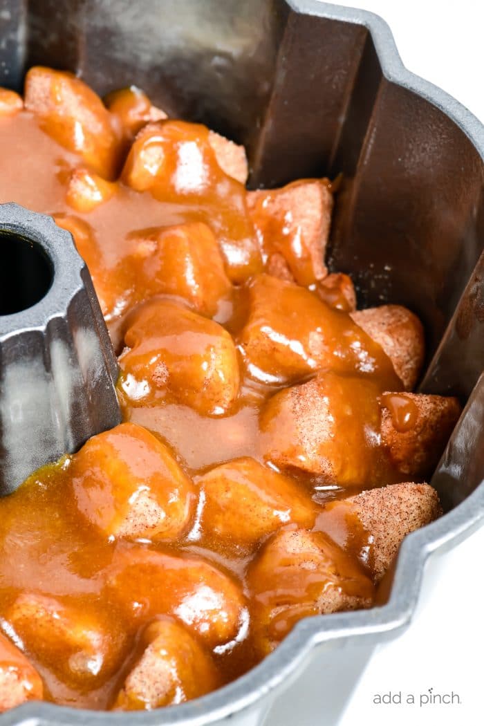 Photograph of caramel topped monkey bread in a bundt pan that is ready to be baked
