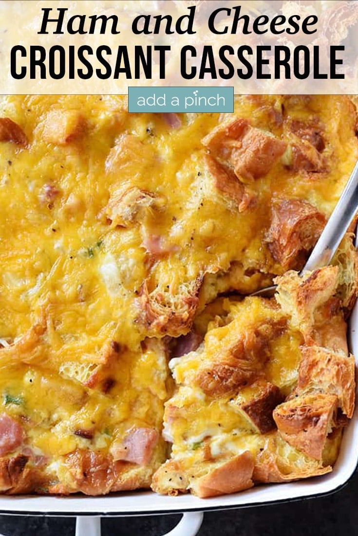 Ham and Cheese Croissant Casserole in white dish with spoon -with text - addapinch.com