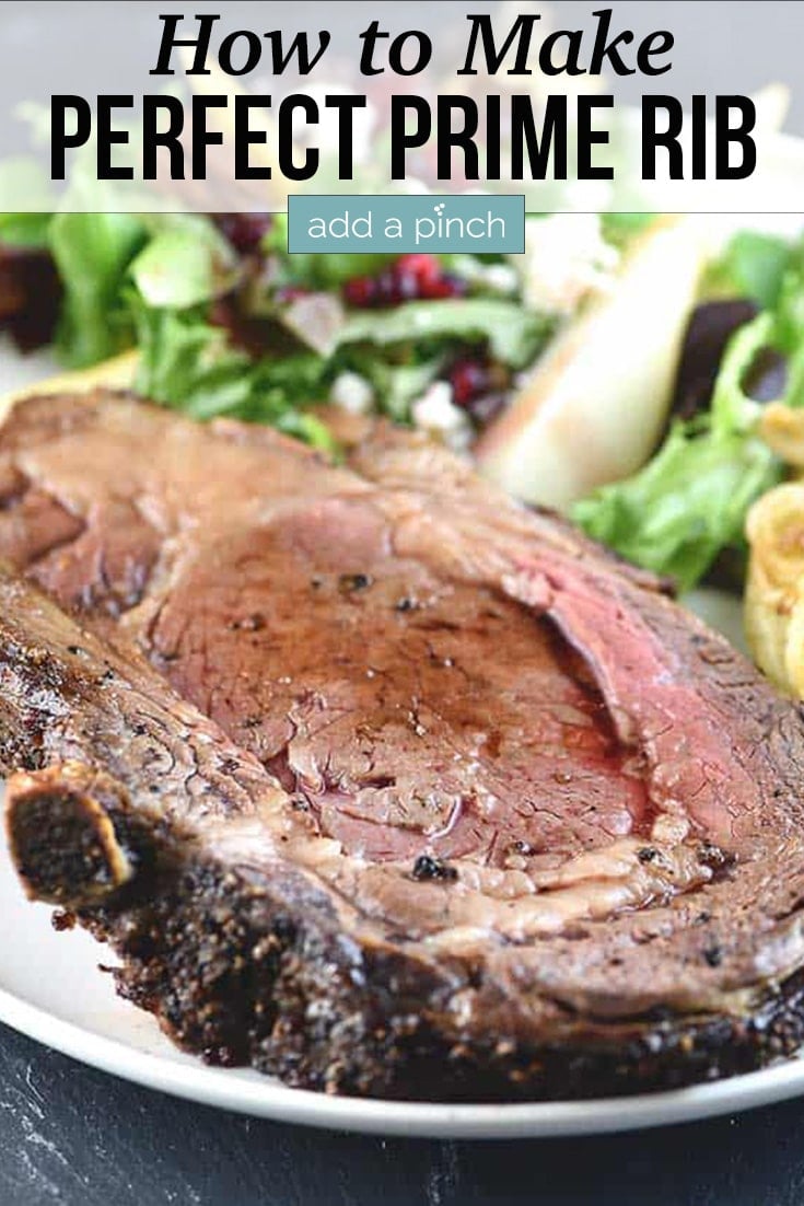 Juicy slice of Prime Rib on plate with salad - with text - addapinch.com