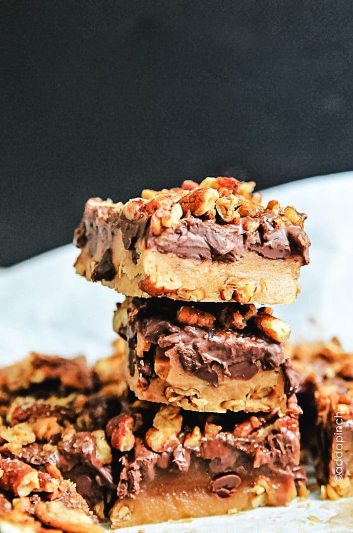 Photograph of homemade buttery toffee with a layer of chocolate and roasted pecans. // addapinch.com