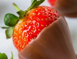 Close photograph of a chocolate covered strawberry.