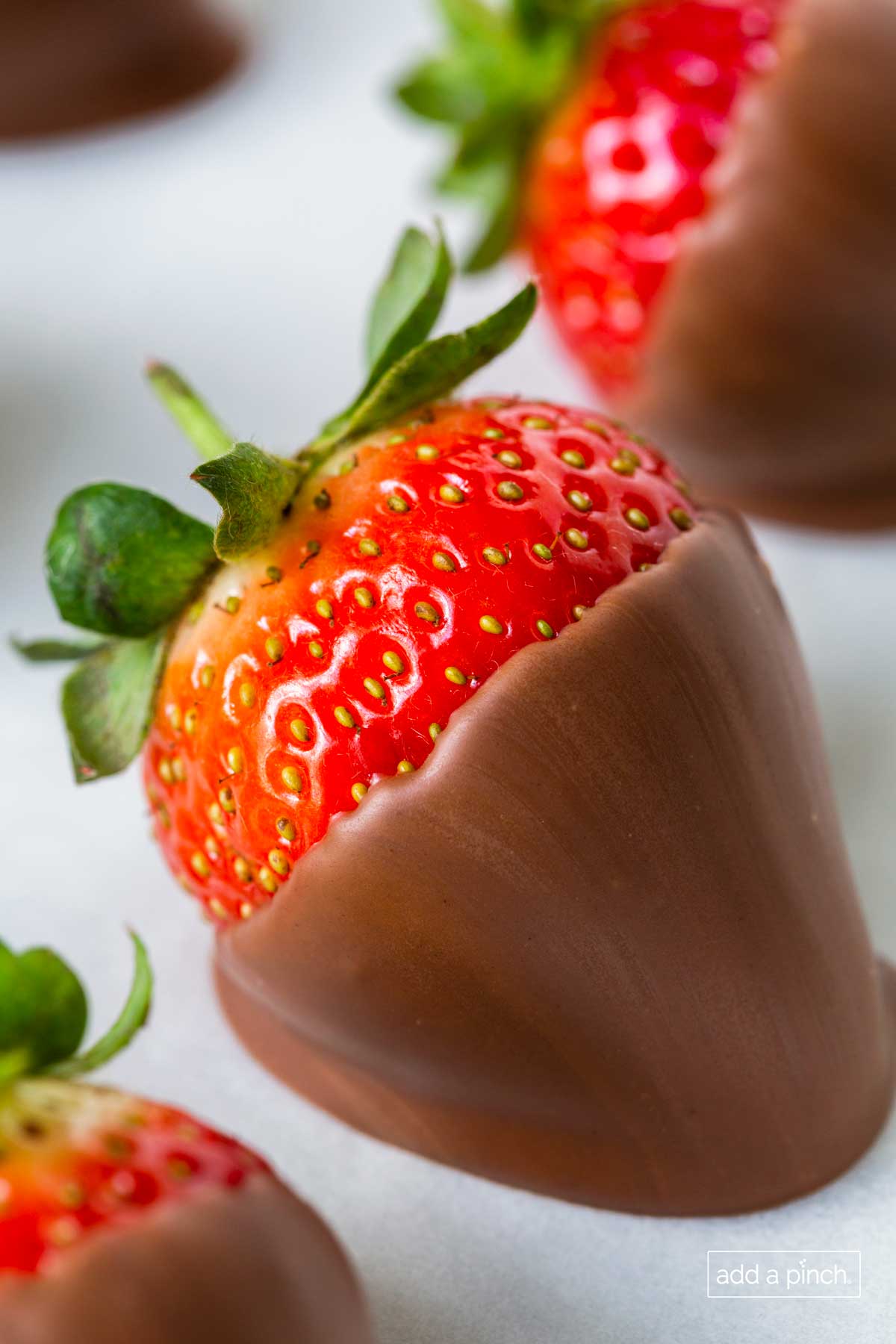 Close photograph of a chocolate covered strawberry.