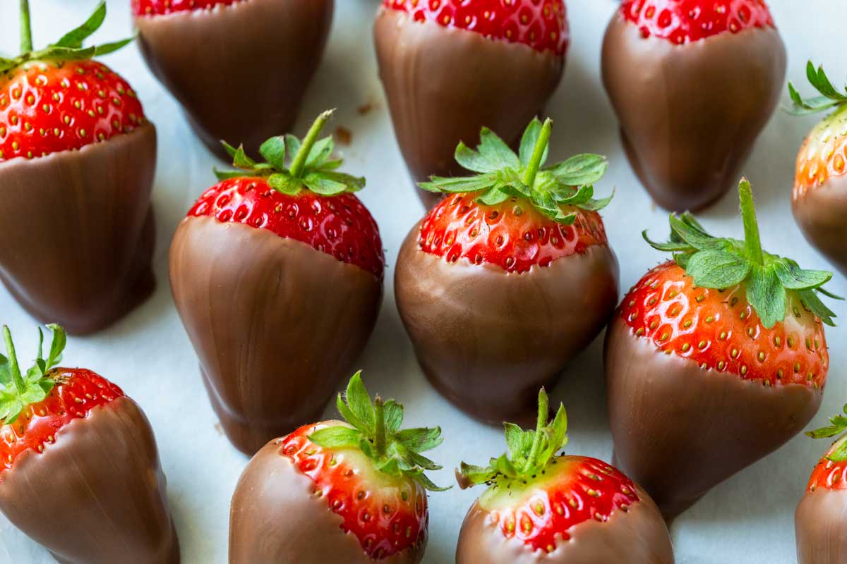 Photo of chocolate covered strawberries on a white platter.