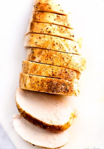 Baked chicken breast on a white board