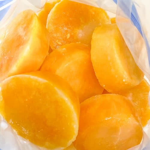 Photograph of frozen eggs in a freezer safe bag to demonstrate how to freeze fresh eggs. / addapinch.com