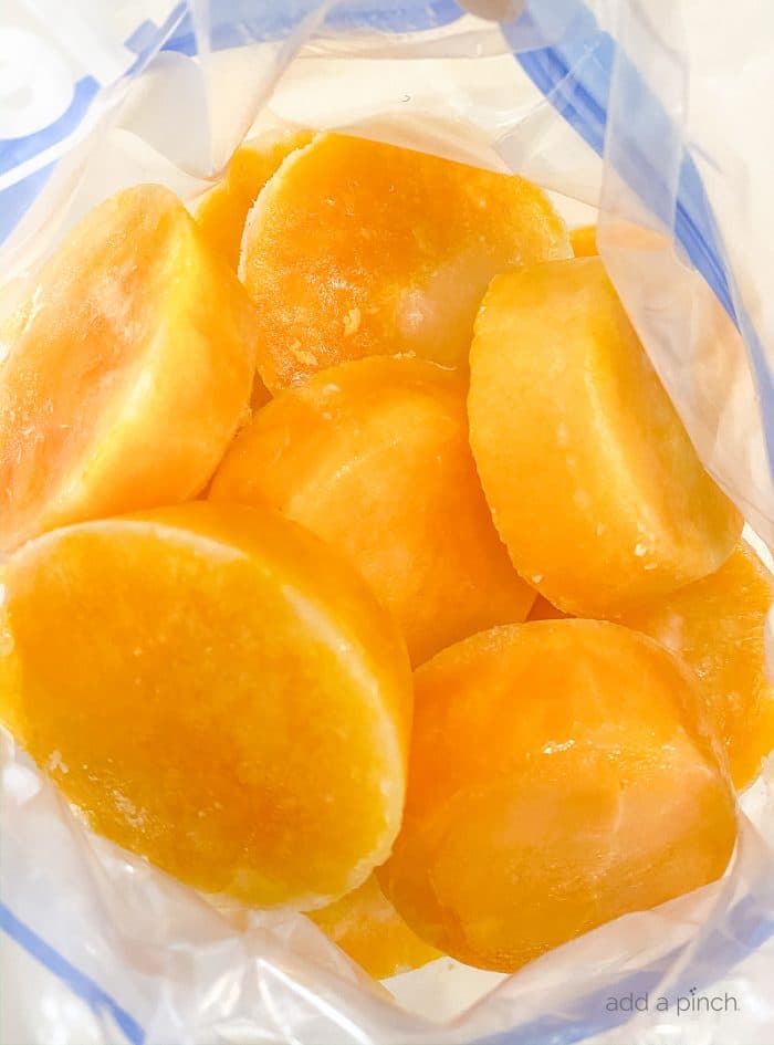 Photograph of frozen eggs in a freezer safe bag to demonstrate how to freeze fresh eggs. / addapinch.com