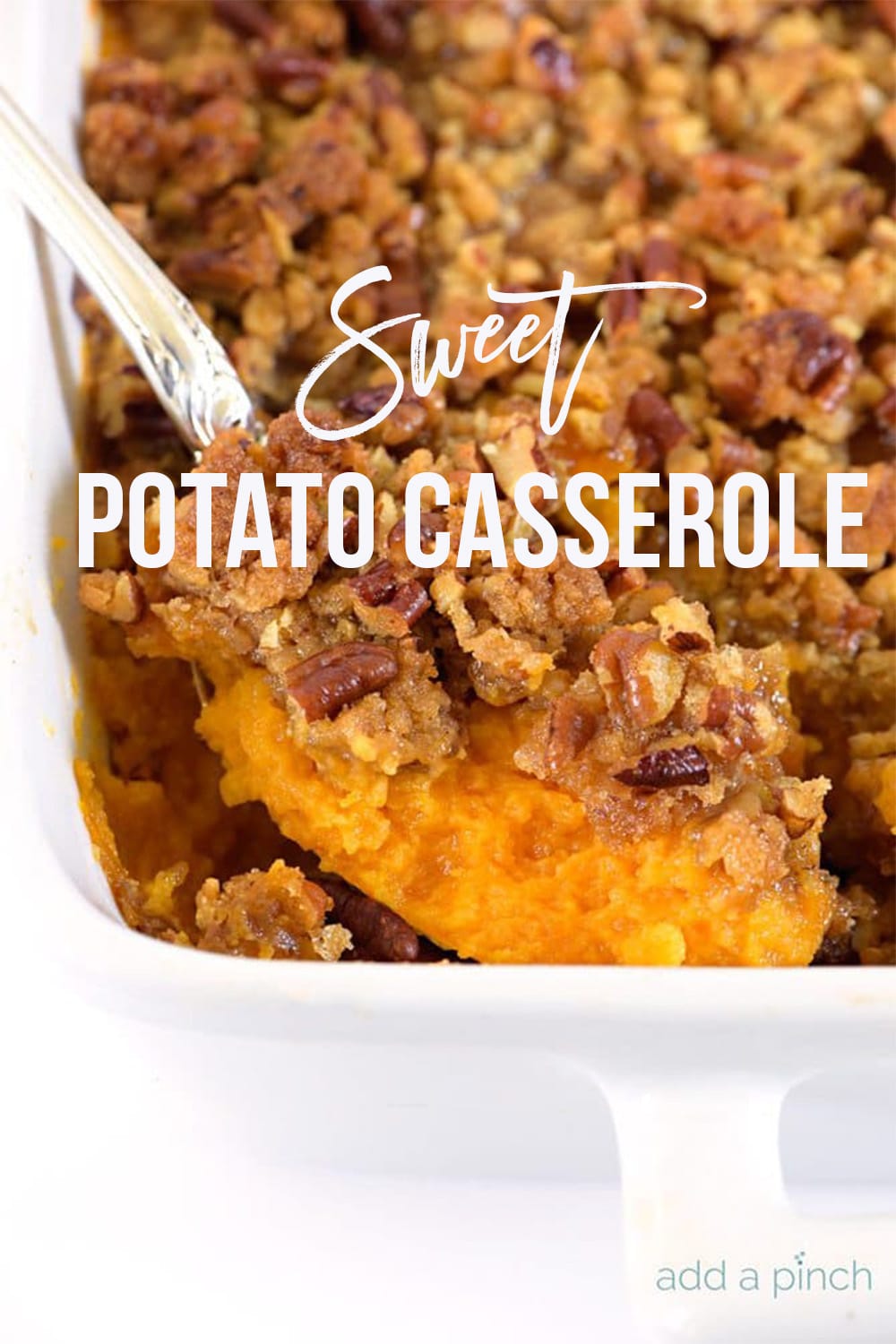 Southern Sweet Potato Casserole with Pecan topping in white casserole dish - with white text - addapinch.com