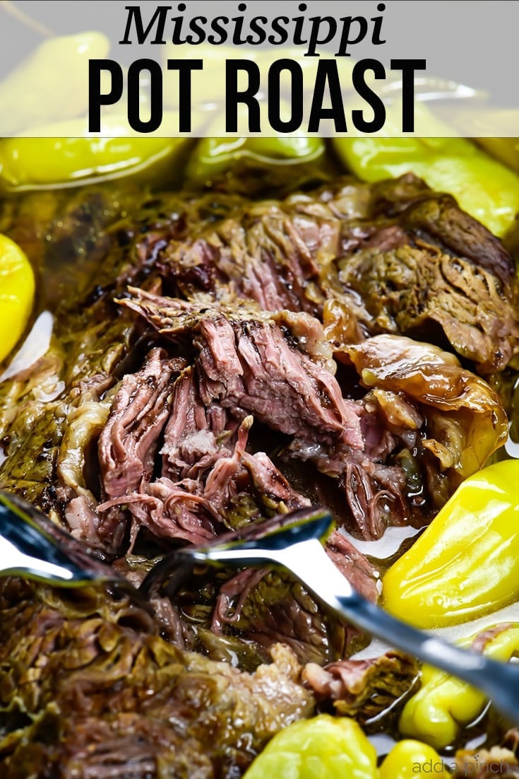 Shredded pot roast surrounded by pepperoncini peppers, two forks - with text - addapinch.com
