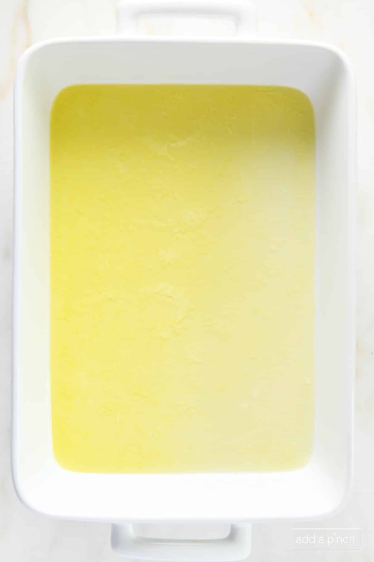 Melted butter in a white baking dish.