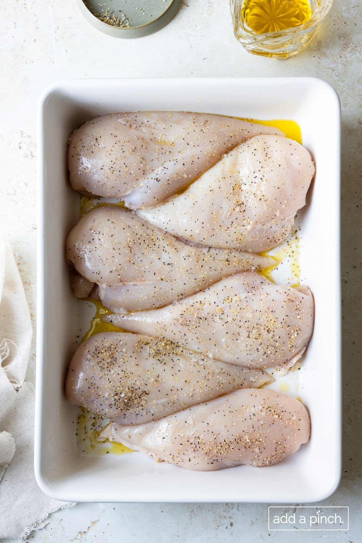 Photo of chicken breasts ready to be baked in the oven.