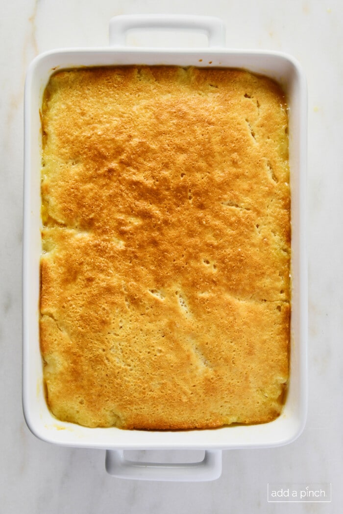 Baked cobbler in a white baking dish.