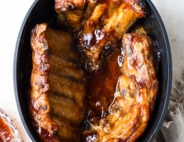 Slab of ribs cooked in a slow cooker with bbq sauce.