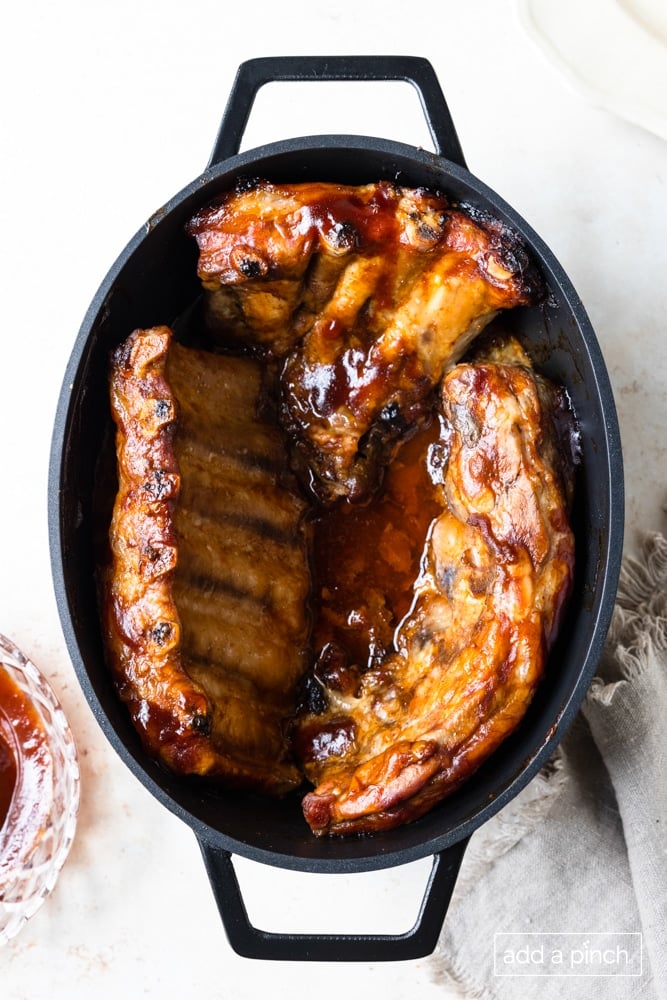Slab of ribs cooked in a slow cooker with bbq sauce.