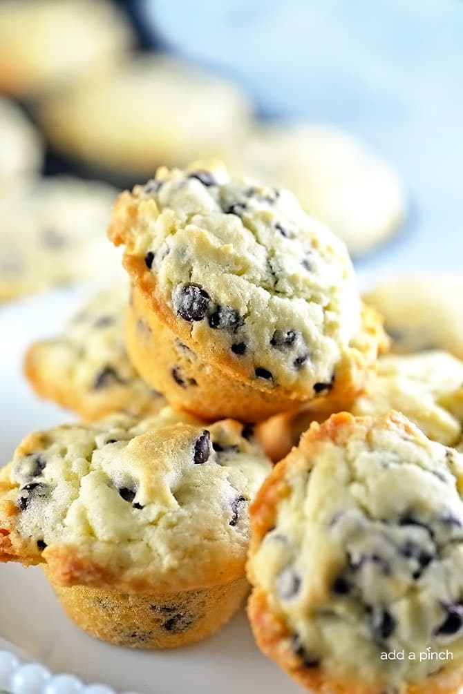 Photograph of stack of chocolate chip muffins on a white plate. // addapinch.com