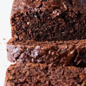 Photo of chocolate zucchini bread on a white platter.