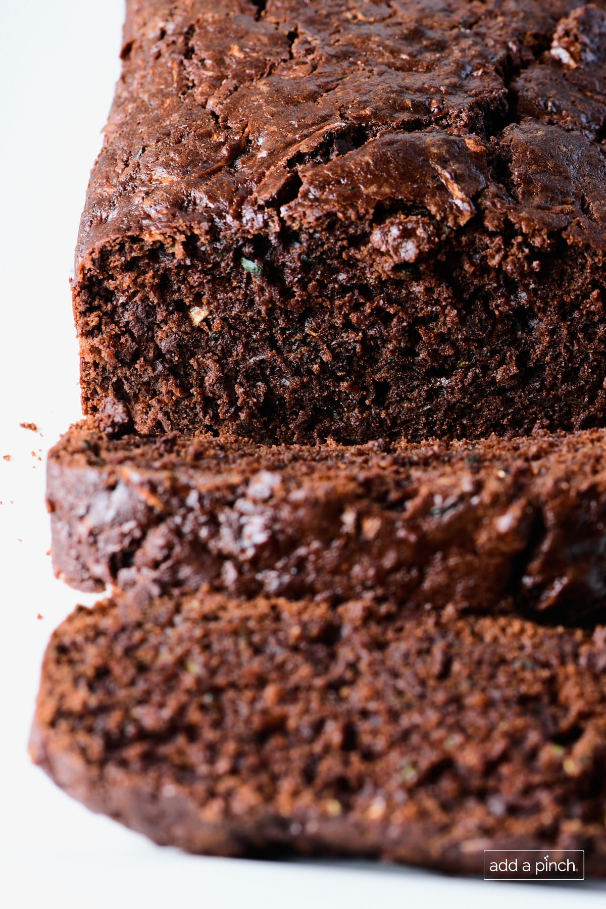Photo of chocolate zucchini bread on a white platter.