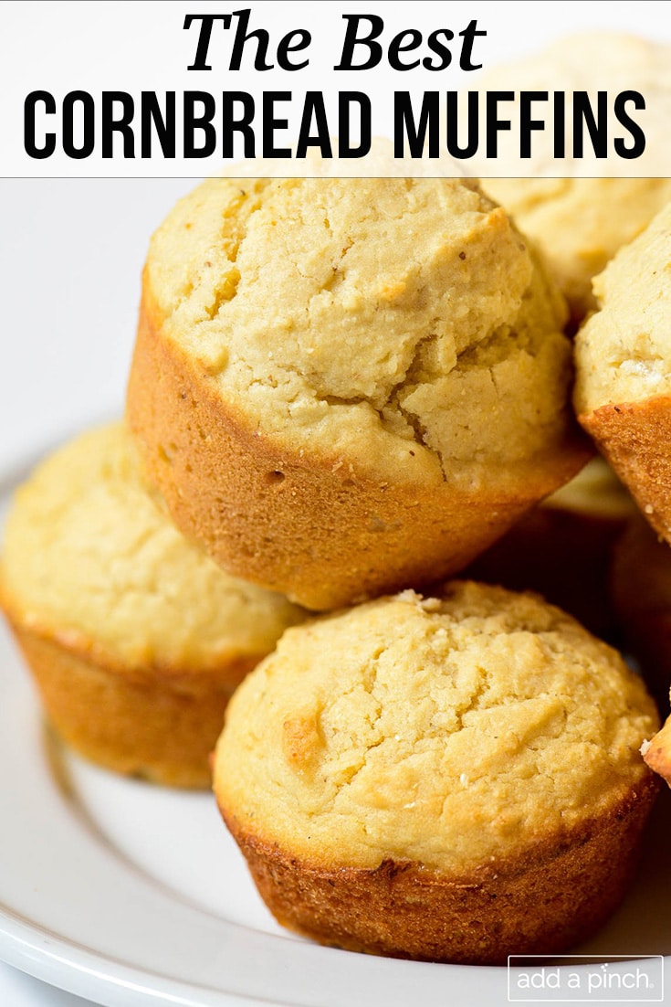Stack of cornbread muffins on white plate - with text - addapinch.com