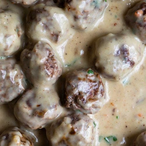 Photo of Swedish Meatballs in a rich, creamy sauce in a skillet.
