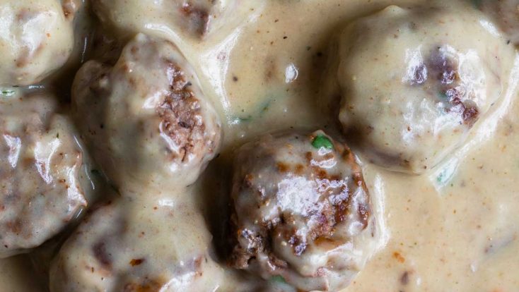 Photo of Swedish Meatballs in a rich, creamy sauce in a skillet.