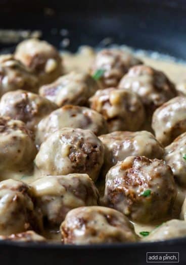 Close up image of meatballs smothered in creamy Swedish Meatball sauce.
