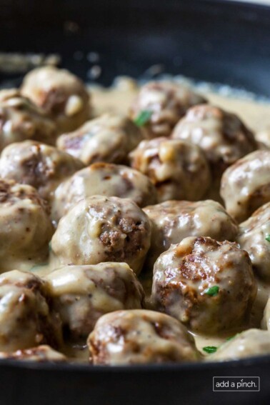 Close up image of meatballs smothered in creamy Swedish Meatball sauce.