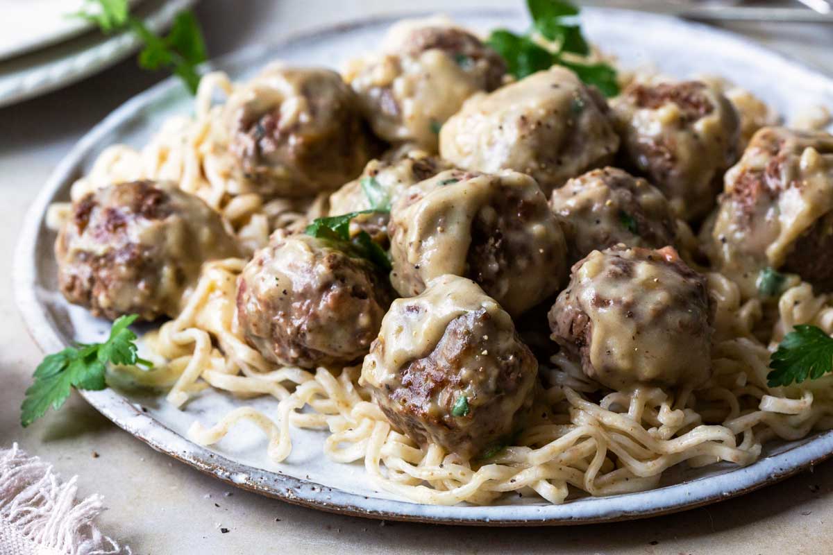 Photograph of Swedish Meatballs on a white plate.