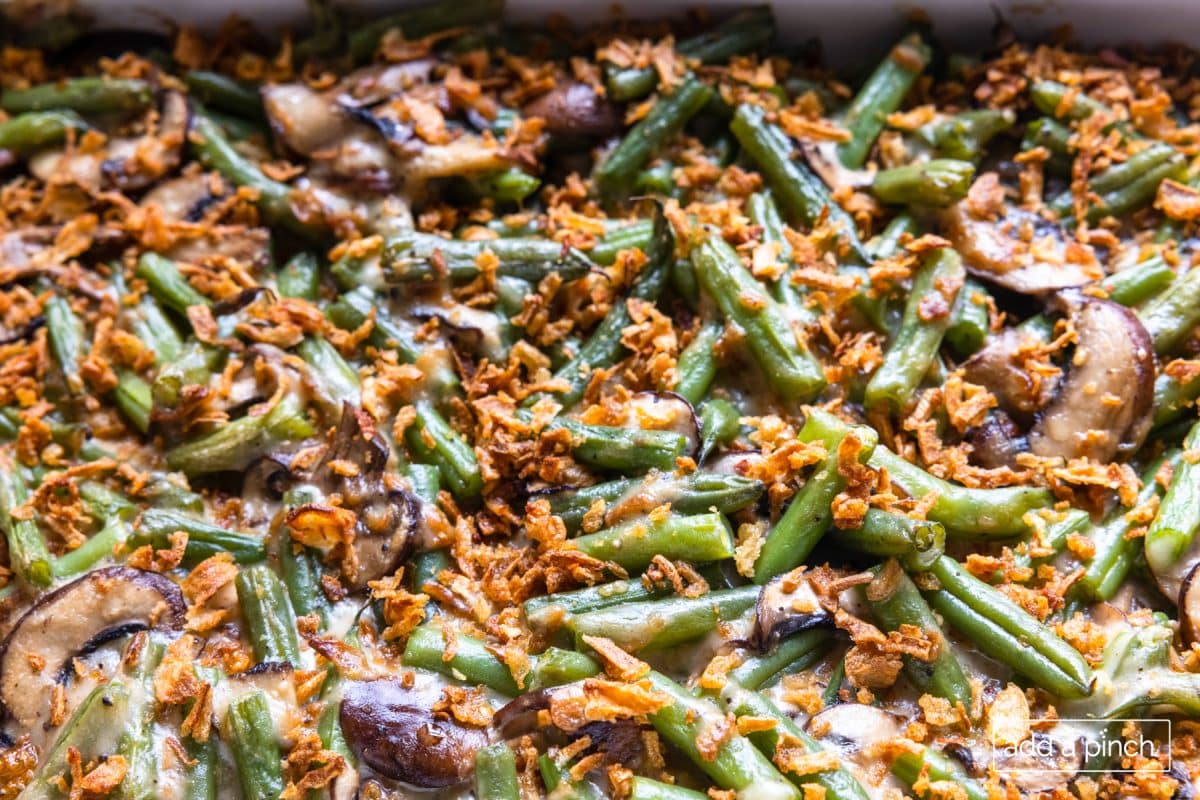 Baked and ready to serve green bean casserole in a white baking dish.