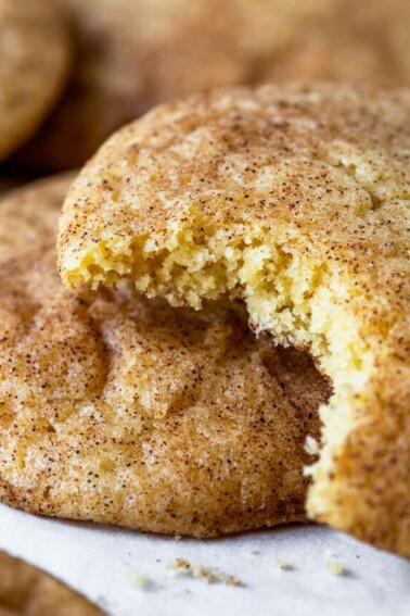 Closeup photo of snickerdoodle with a bite out to show the soft texture.