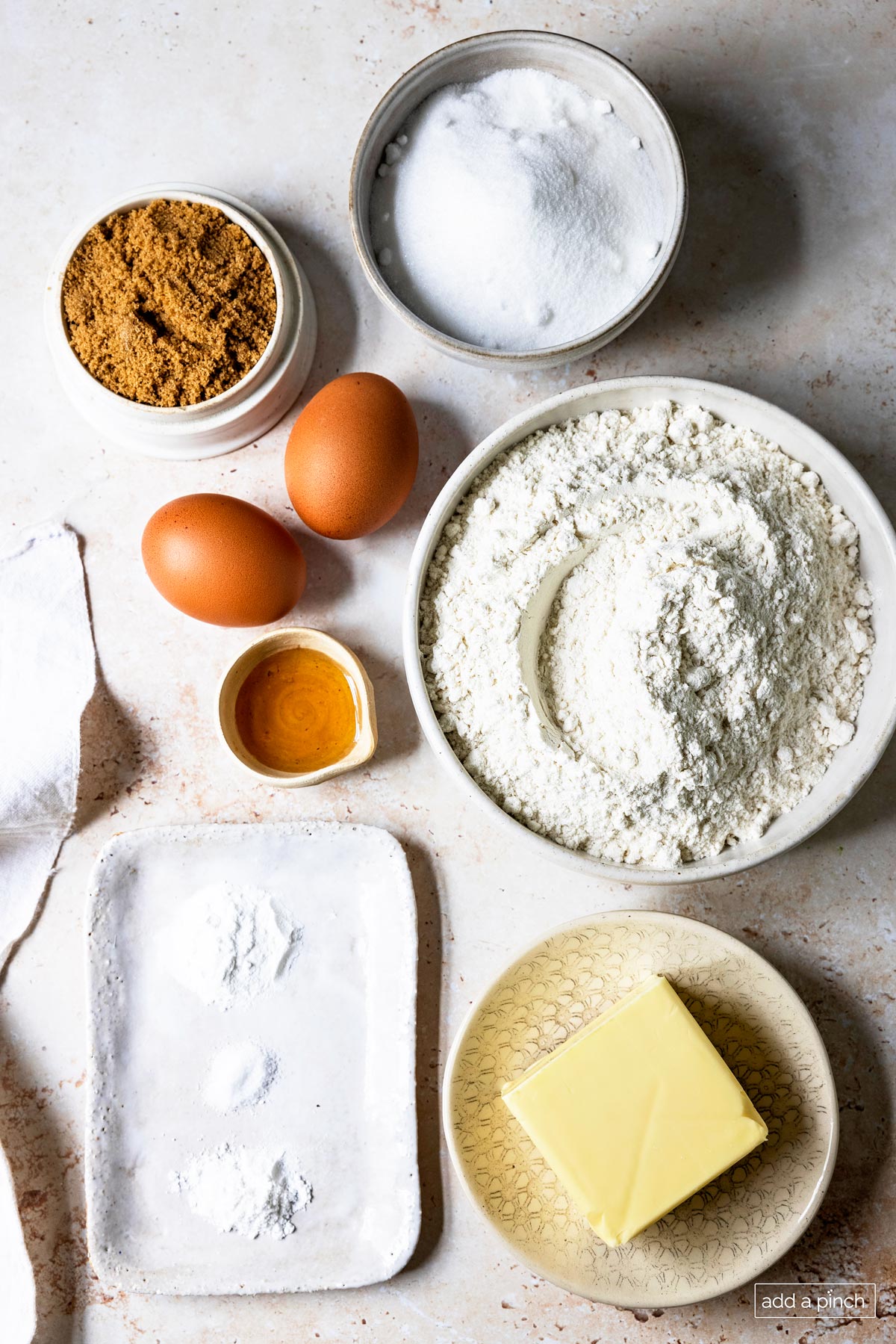 Image of snickerdoodle recipe ingredients: sugar, brown sugar, flour, butter, cream of tartar, baking soda, salt, eggs, and vanilla.